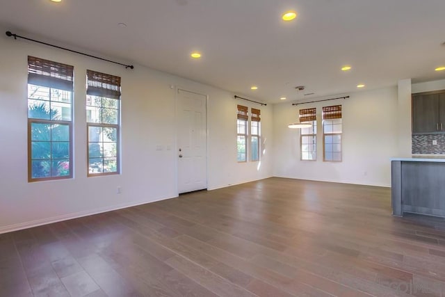 unfurnished living room featuring dark wood-type flooring