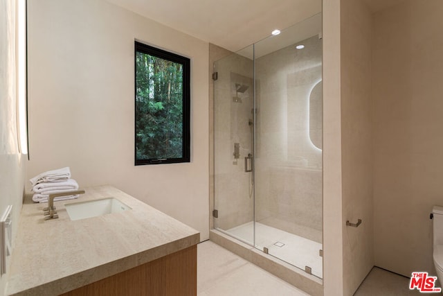 bathroom with vanity and a shower with shower door