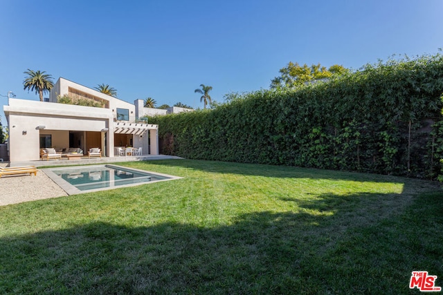 rear view of house featuring a pergola, a fenced in pool, a yard, and a patio