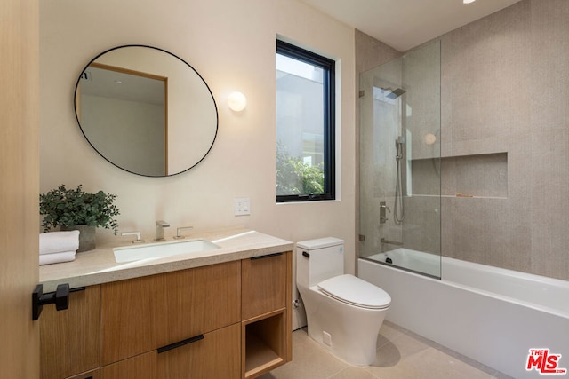 full bathroom with shower / bath combination with glass door, toilet, tile patterned floors, and vanity