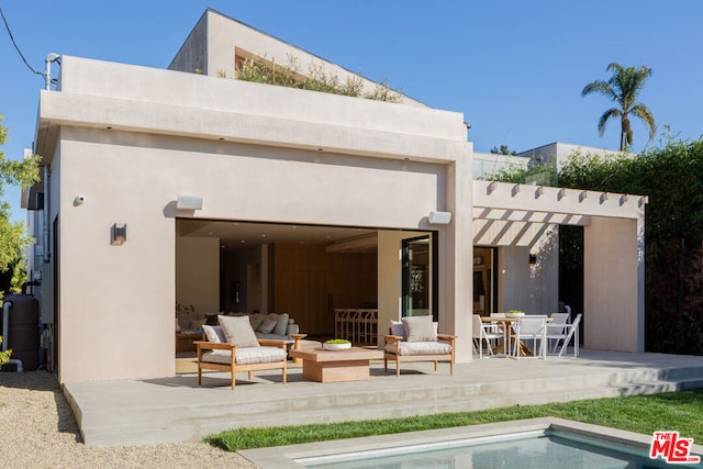 rear view of house featuring a patio and an outdoor living space