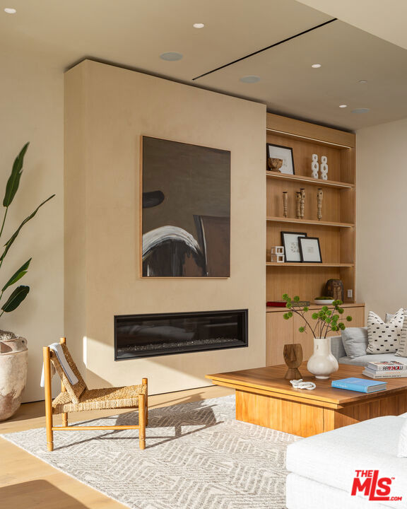 living room featuring hardwood / wood-style floors and built in features