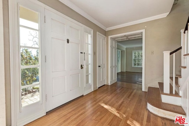 entrance foyer featuring crown molding and hardwood / wood-style flooring