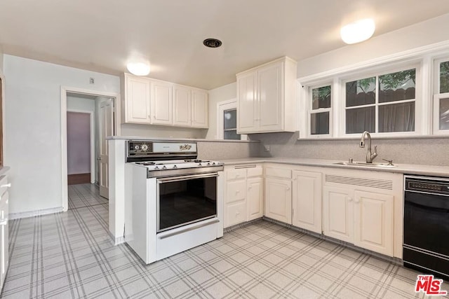 kitchen featuring dishwasher, white range oven, white cabinetry, and sink