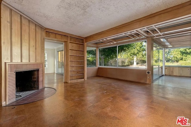 unfurnished sunroom featuring a brick fireplace