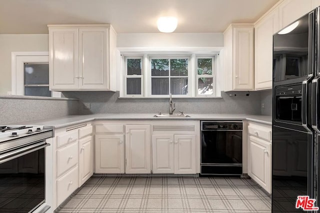 kitchen with sink, white cabinets, and black appliances