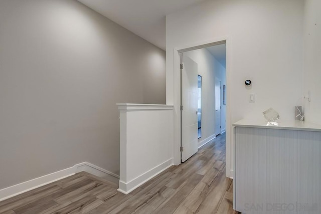 corridor with light hardwood / wood-style floors