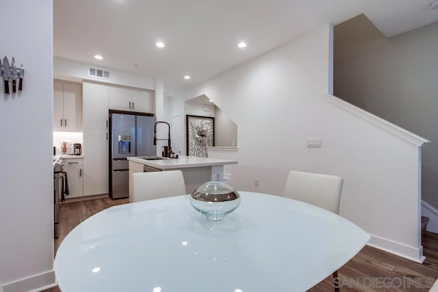 dining room with sink and dark hardwood / wood-style floors