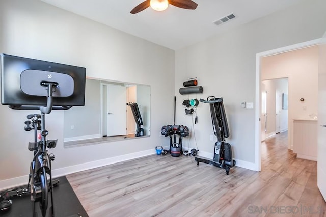 workout area with ceiling fan and light wood-type flooring