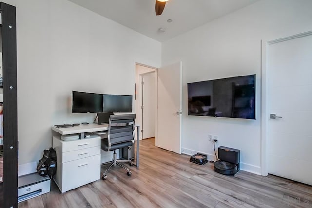 office with ceiling fan and light hardwood / wood-style flooring