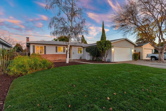 single story home with a lawn and a garage