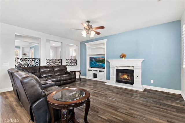 living room with ceiling fan and dark wood-type flooring