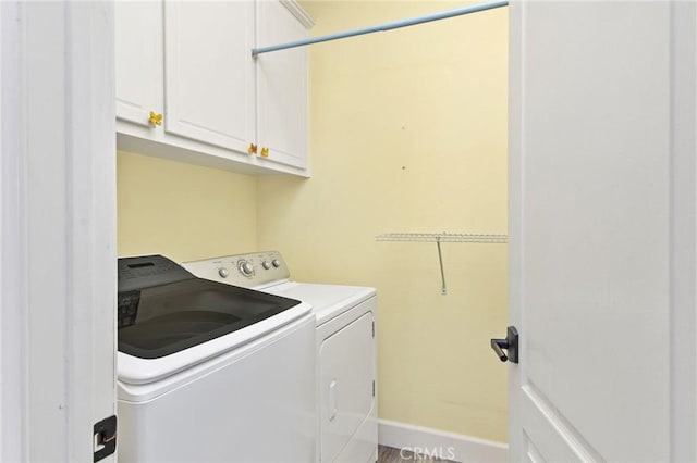 laundry area with cabinets and washing machine and clothes dryer