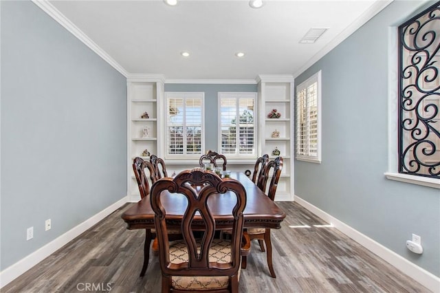 dining area featuring built in shelves, crown molding, and hardwood / wood-style floors