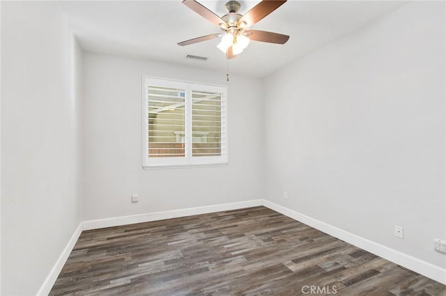 spare room featuring dark wood-type flooring and ceiling fan