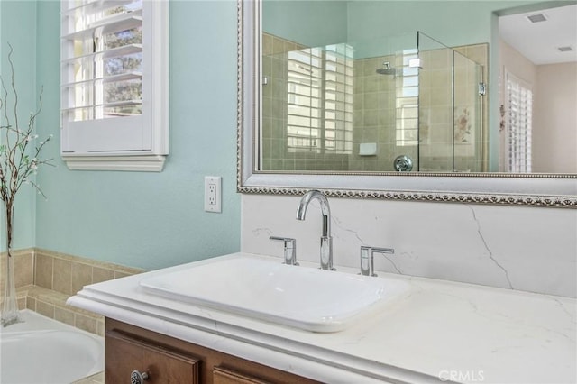 bathroom with plus walk in shower and vanity