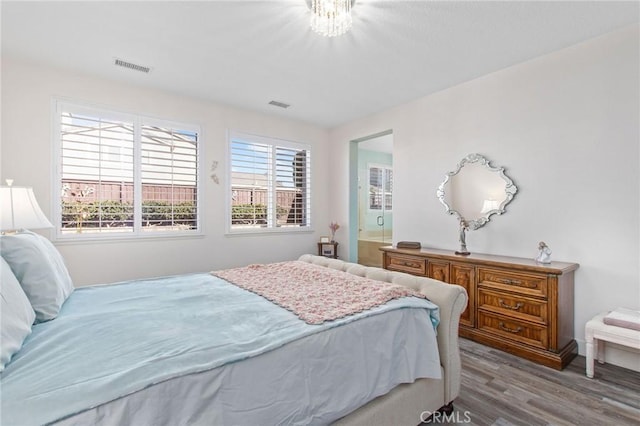 bedroom with multiple windows and light wood-type flooring