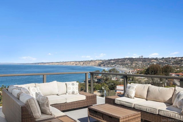 balcony featuring an outdoor living space and a water view