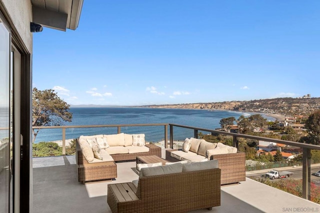 balcony with a water view and an outdoor hangout area