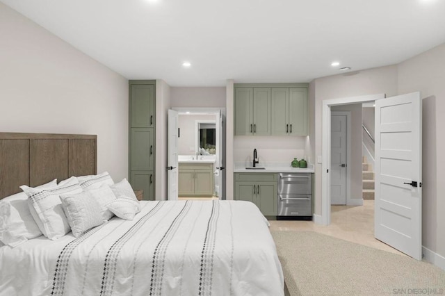 bedroom featuring ensuite bath and sink