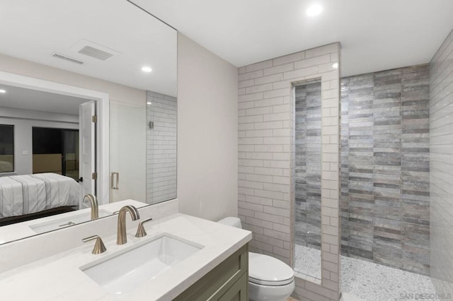 bathroom featuring toilet, a shower with door, and vanity