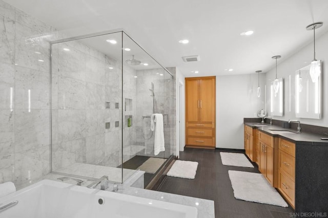 bathroom with shower with separate bathtub and vanity