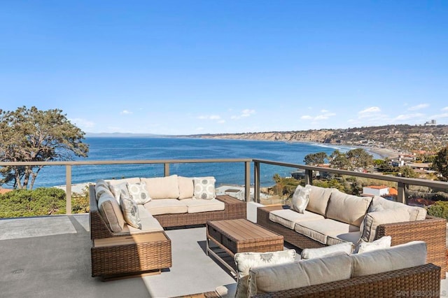 balcony with an outdoor hangout area and a water view