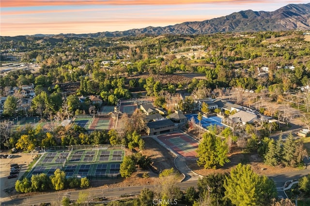 aerial view at dusk featuring a mountain view