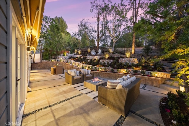 patio terrace at dusk featuring an outdoor living space with a fire pit