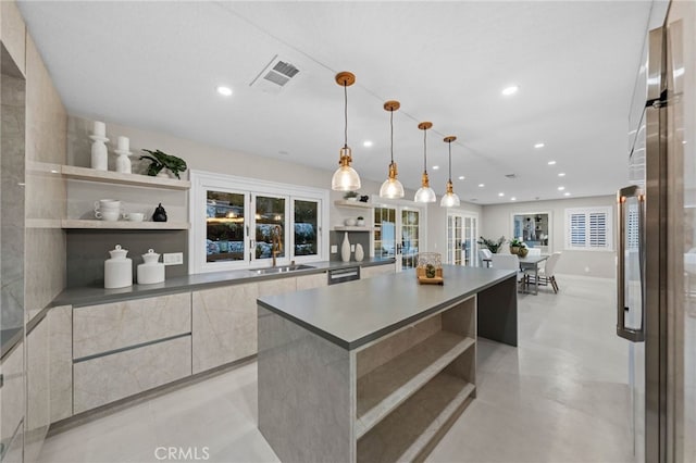 kitchen featuring sink, a large island, black dishwasher, refrigerator, and pendant lighting