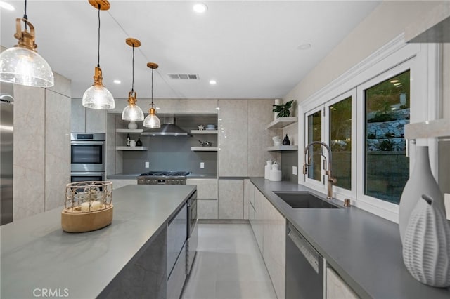 kitchen featuring dishwasher, hanging light fixtures, double oven, sink, and wall chimney range hood