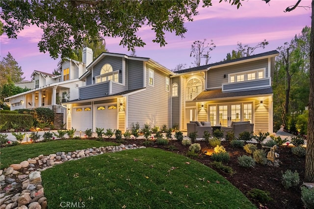 view of front of home featuring a yard and a garage