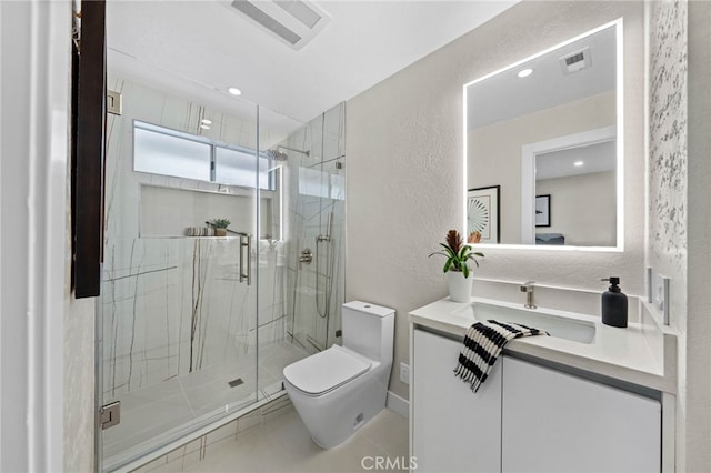 bathroom featuring toilet, a shower with door, vanity, and tile patterned floors