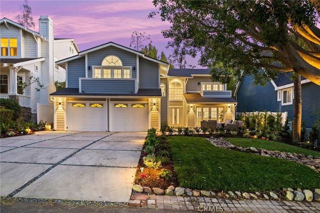 view of front of home with a lawn and a garage