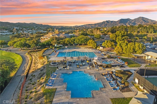 pool at dusk with a mountain view