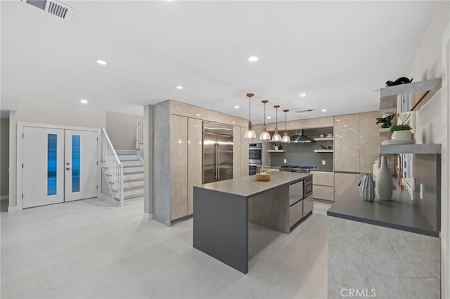 kitchen with a center island, french doors, pendant lighting, range hood, and premium appliances