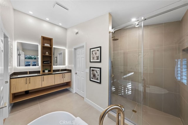 bathroom with tile patterned flooring, vanity, and shower with separate bathtub