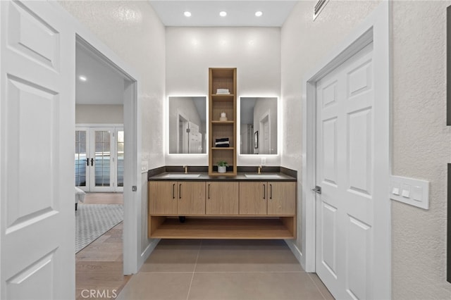 bathroom with vanity, french doors, and tile patterned floors