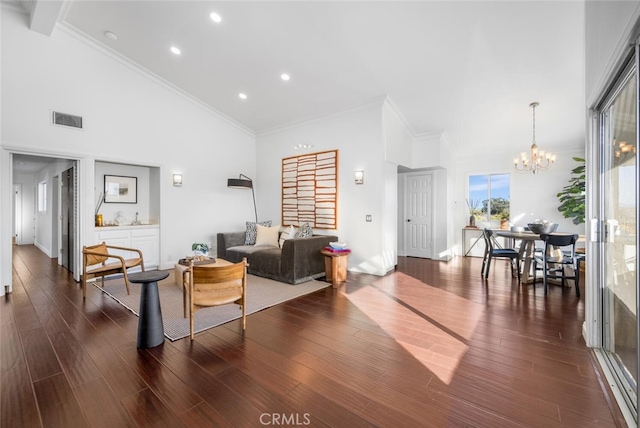 living room with a notable chandelier, high vaulted ceiling, and dark hardwood / wood-style floors