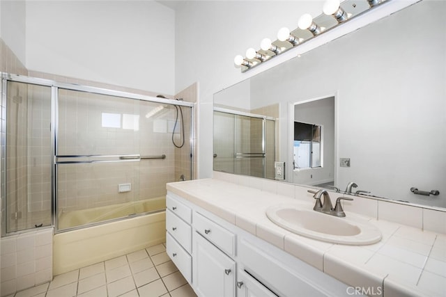 bathroom with bath / shower combo with glass door, tile patterned floors, and vanity