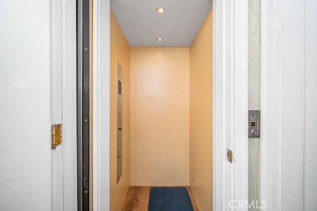 hall featuring elevator and wood-type flooring