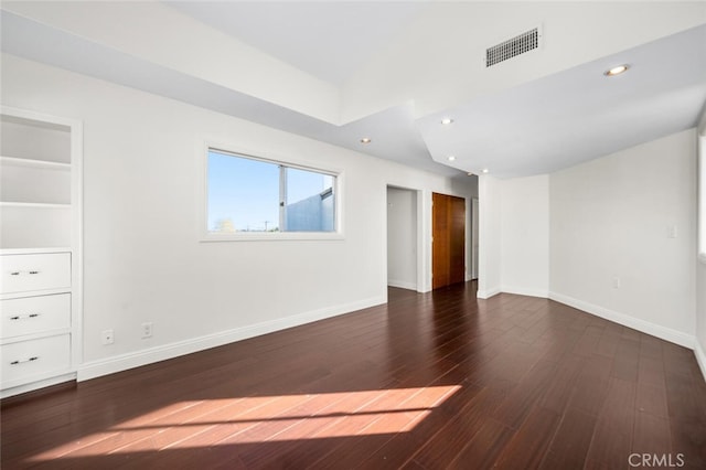 spare room featuring dark wood-type flooring