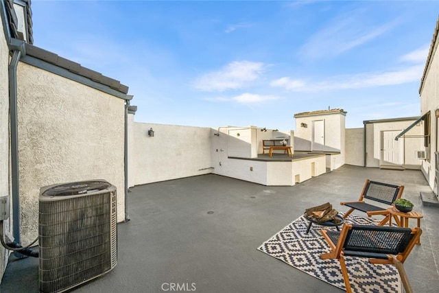 view of patio featuring central air condition unit and a storage unit