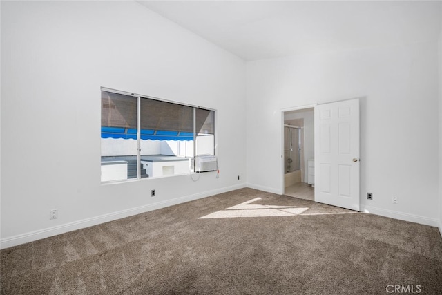 unfurnished bedroom with a towering ceiling and carpet