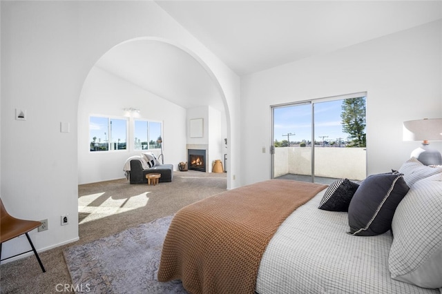 bedroom featuring access to outside, carpet flooring, and lofted ceiling