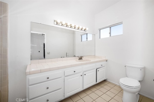 bathroom featuring toilet, vanity, and tile patterned flooring