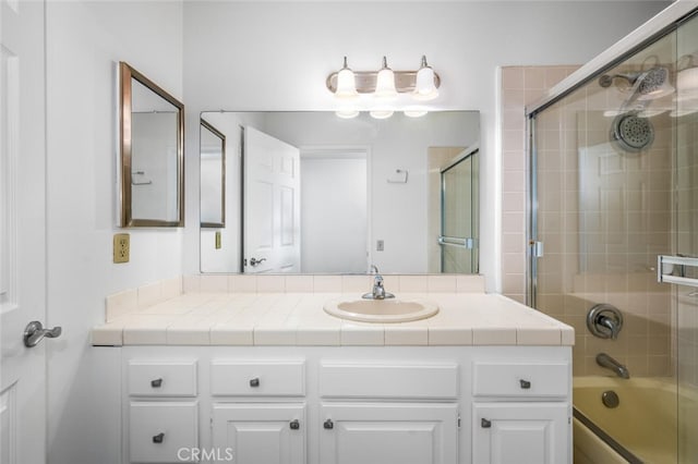 bathroom with enclosed tub / shower combo and vanity