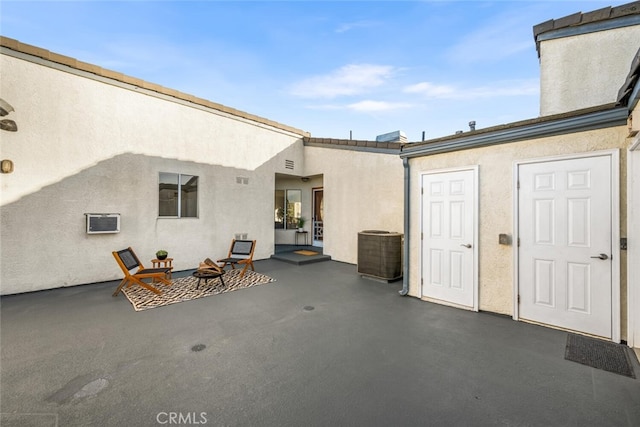 view of patio / terrace featuring an outdoor fire pit and central AC