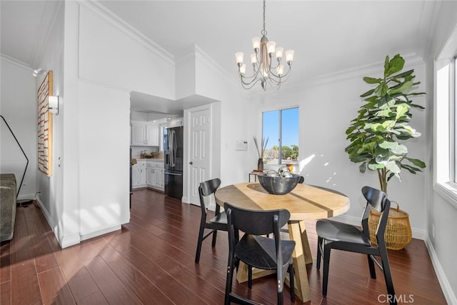 dining area featuring a healthy amount of sunlight, ornamental molding, a chandelier, and dark hardwood / wood-style floors