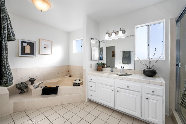 bathroom with tile patterned floors, a wealth of natural light, vanity, and shower with separate bathtub